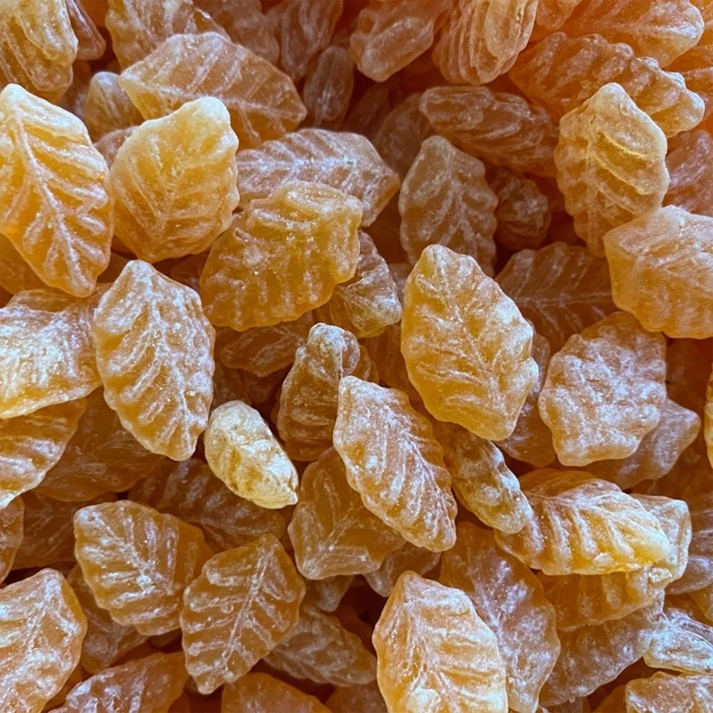 Bonbons pêche verveine en sachet transparent, texture brillante.
