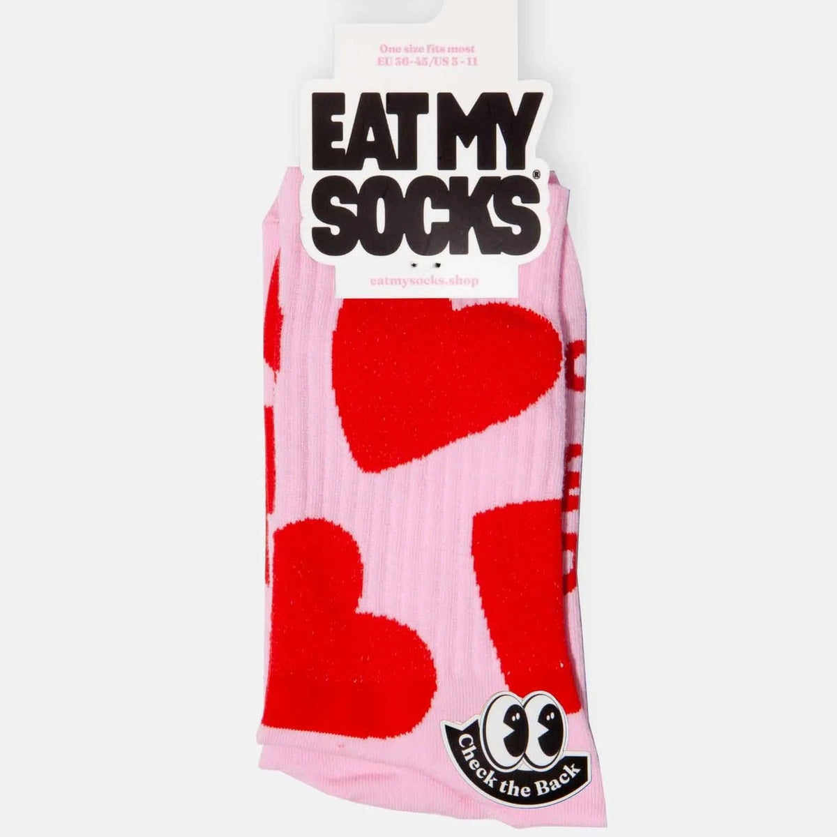 Chaussettes roses à grands cœurs rouges, présentées sur leur carton Eat My Socks