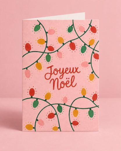 Carte de Noël avec guirlande colorée et message festif