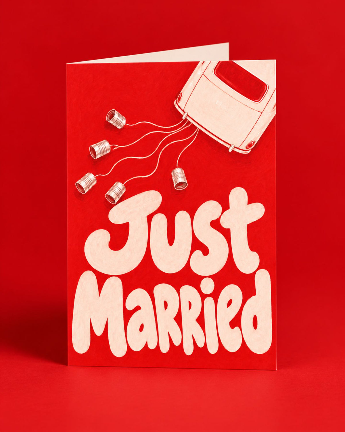 Carte « Just Married » rouge illustrée d’une voiture et de boîtes de conserve